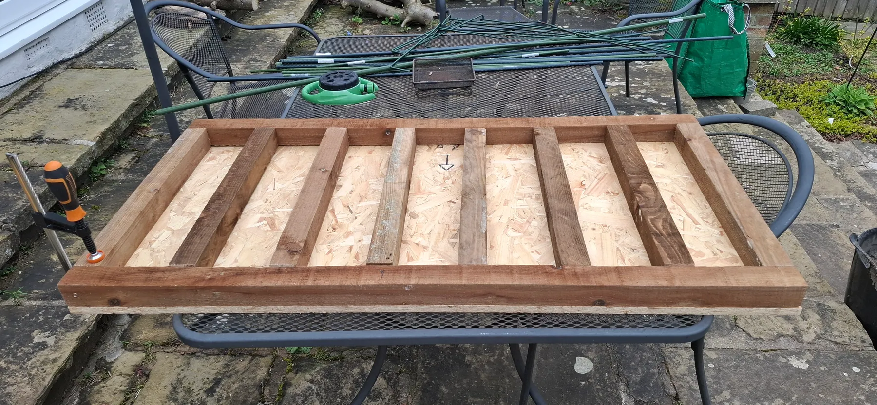 The base frame up on the garden table for the next stage of construction